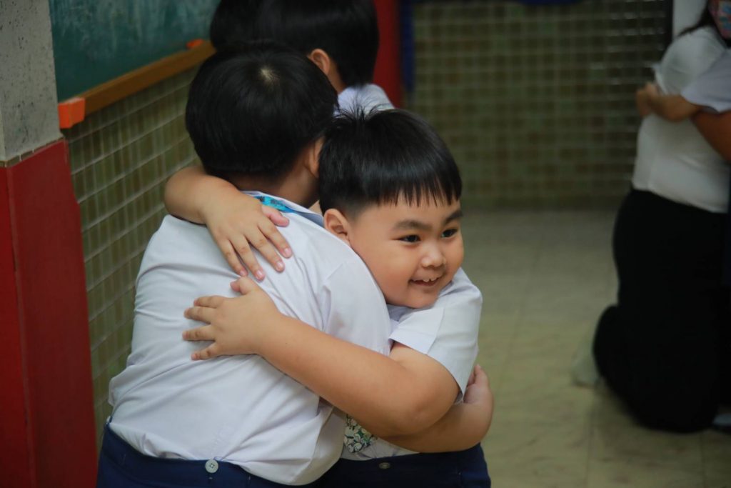 Kids embrace during their Dharma class by Innocent Perception Centre BMSBH teachers.